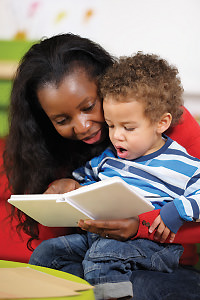 Mother reading book with child